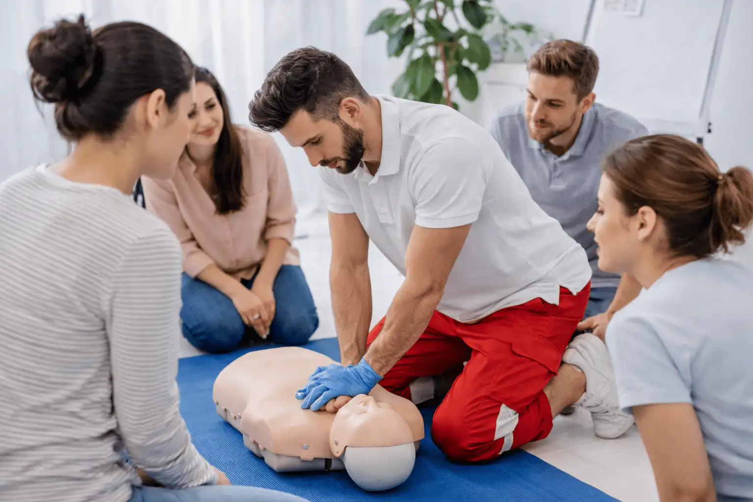 Workplace first aid training with CPR practice